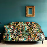 Sofa covered in a printed velvet fabric showcasing a tropical design
