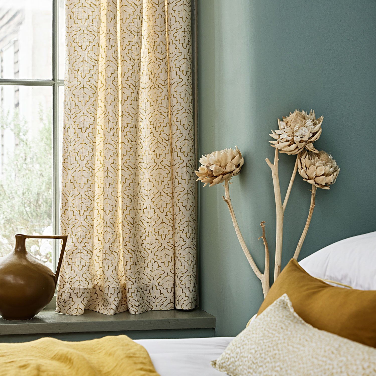 Linen curtains with a hand drawn; mirrored leaf motif pattern in yellow and cream