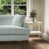 Printed linen fabric – a handy block print pattern in blue and cream – on a sofa