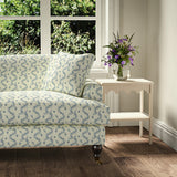Printed linen fabric - a charming marine-style pattern in blue and cream – on a sofa