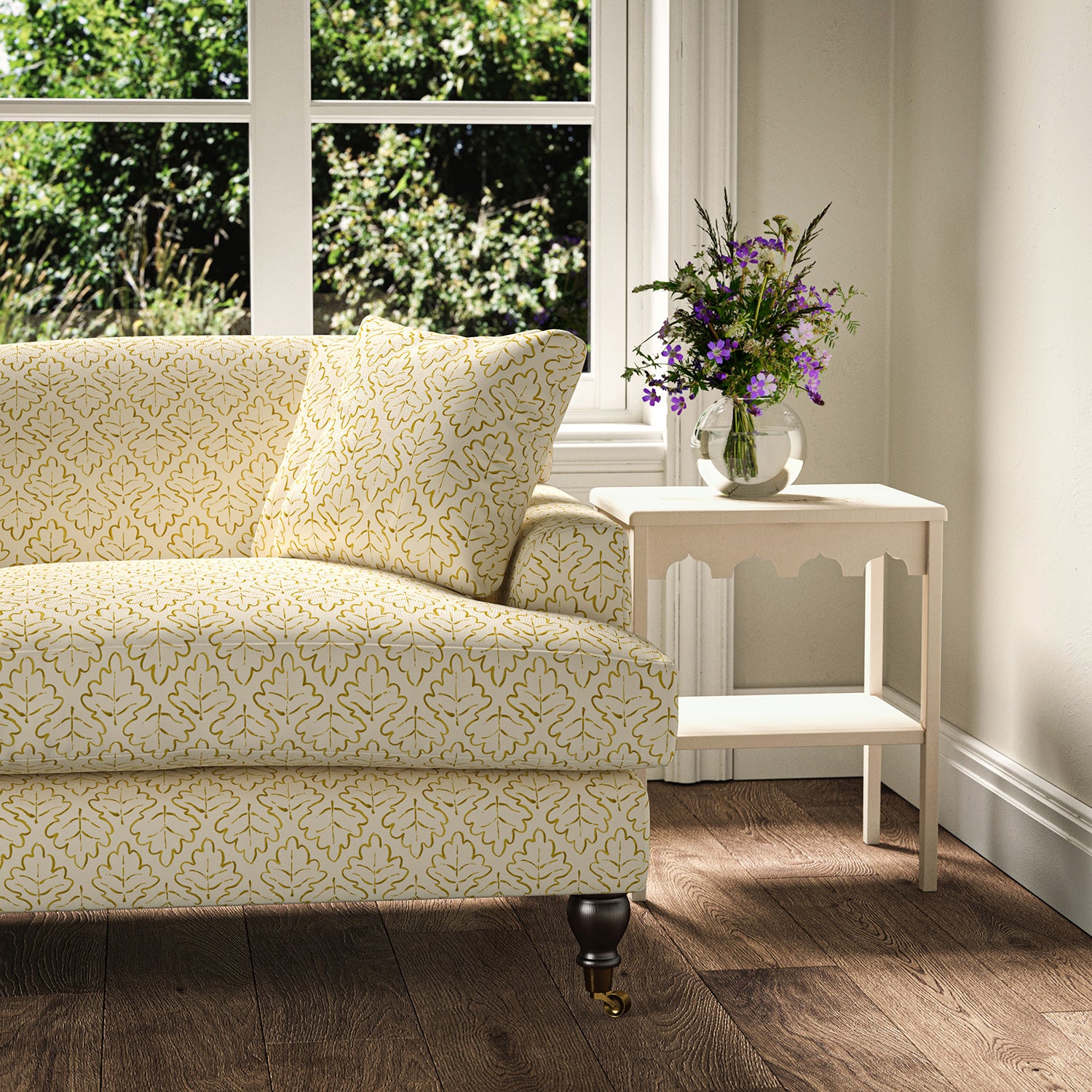 Printed linen fabric – a hand drawn; mirrored leaf motif pattern in yellow and cream – on a sofa