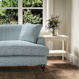 Printed linen fabric – damask-style pattern in blue and cream – on a sofa