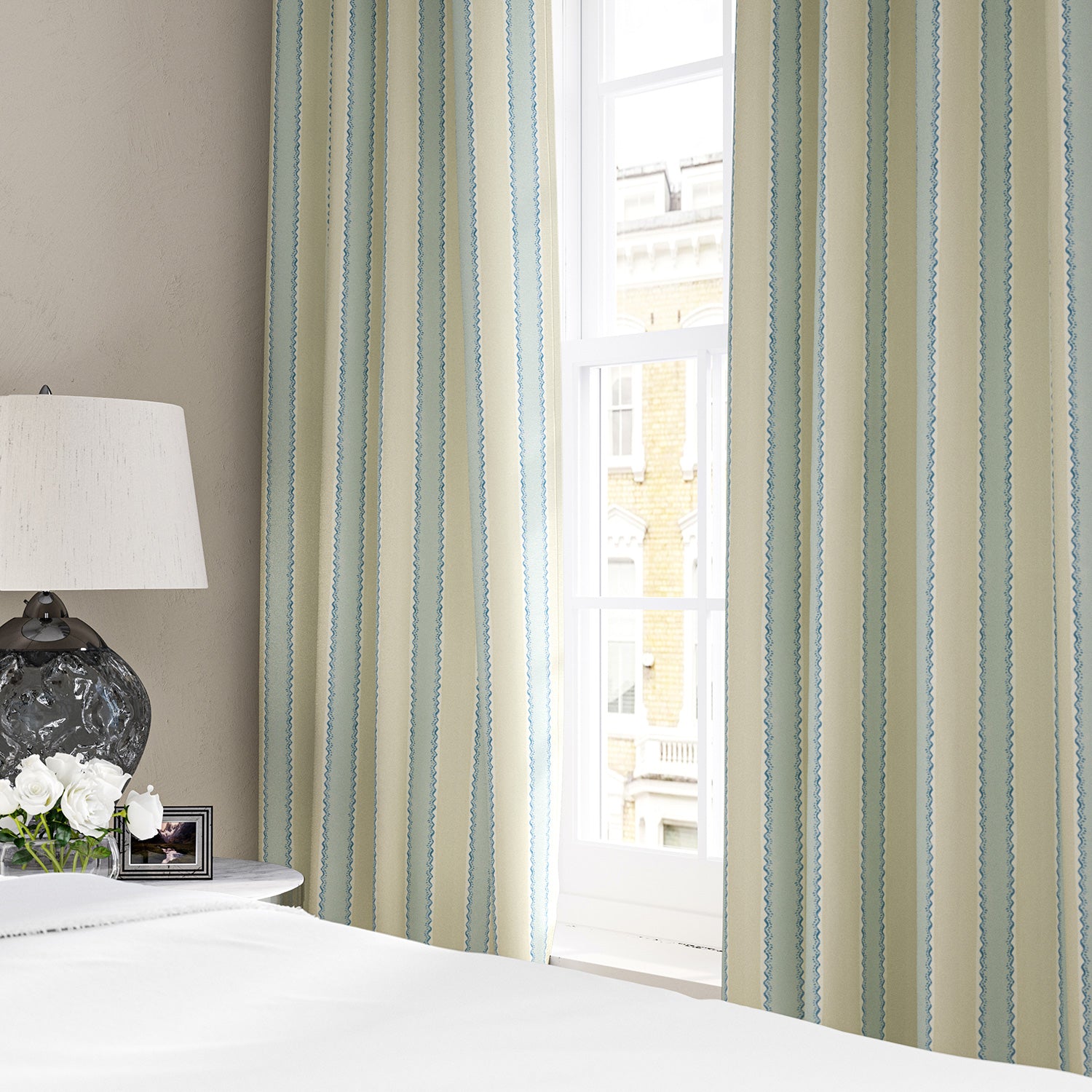 Linen curtains with a bold blocks of colour in this inviting stripe are softened with a painterly finish in blue, cream and white