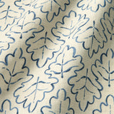 Printed linen fabric sample – a hand drawn; mirrored leaf motif pattern in blue and cream