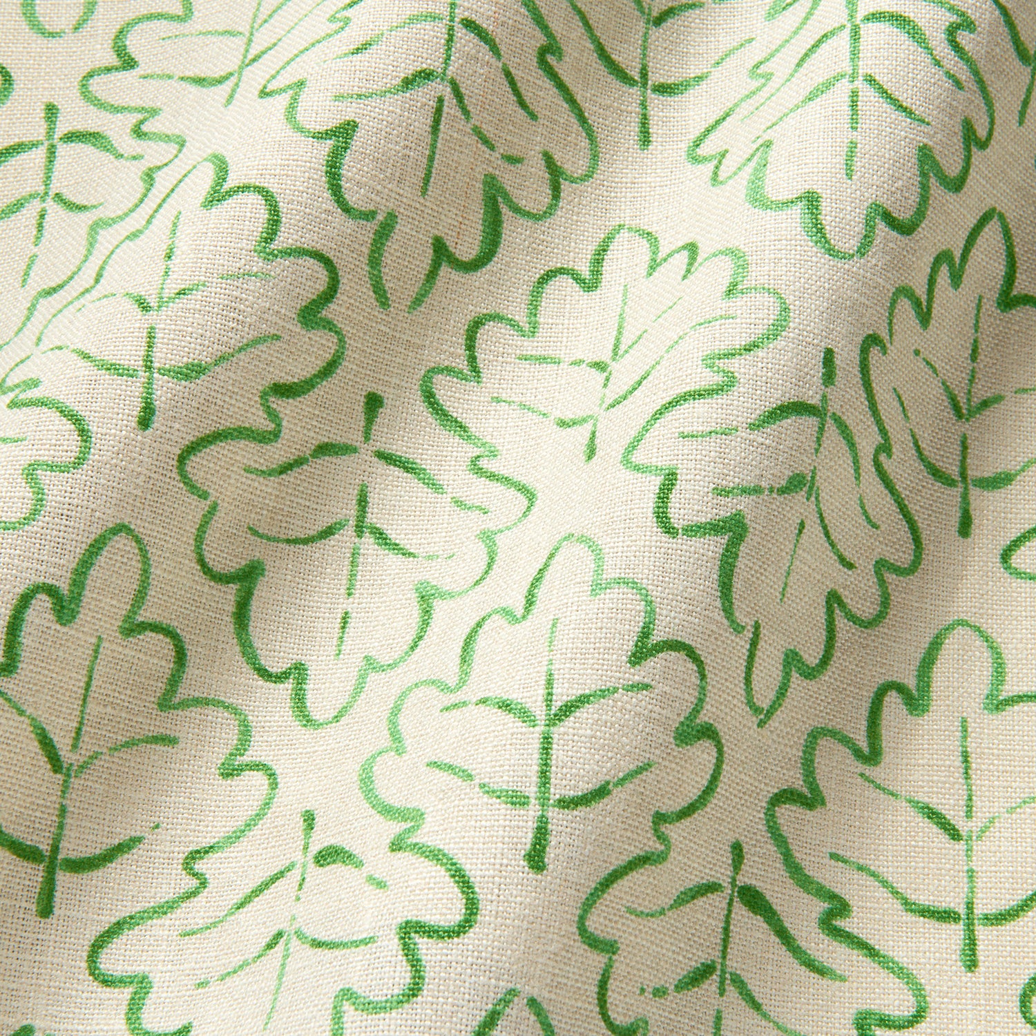 Printed linen fabric sample – a hand drawn; mirrored leaf motif pattern in green and cream