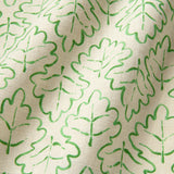 Printed linen fabric sample – a hand drawn; mirrored leaf motif pattern in green and cream