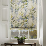 Blind in a printed linen fabric with a wisteria floral pattern in yellow, green and blue colours.