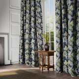 Curtains in a printed linen fabric with a wisteria floral pattern in blue and green colours.