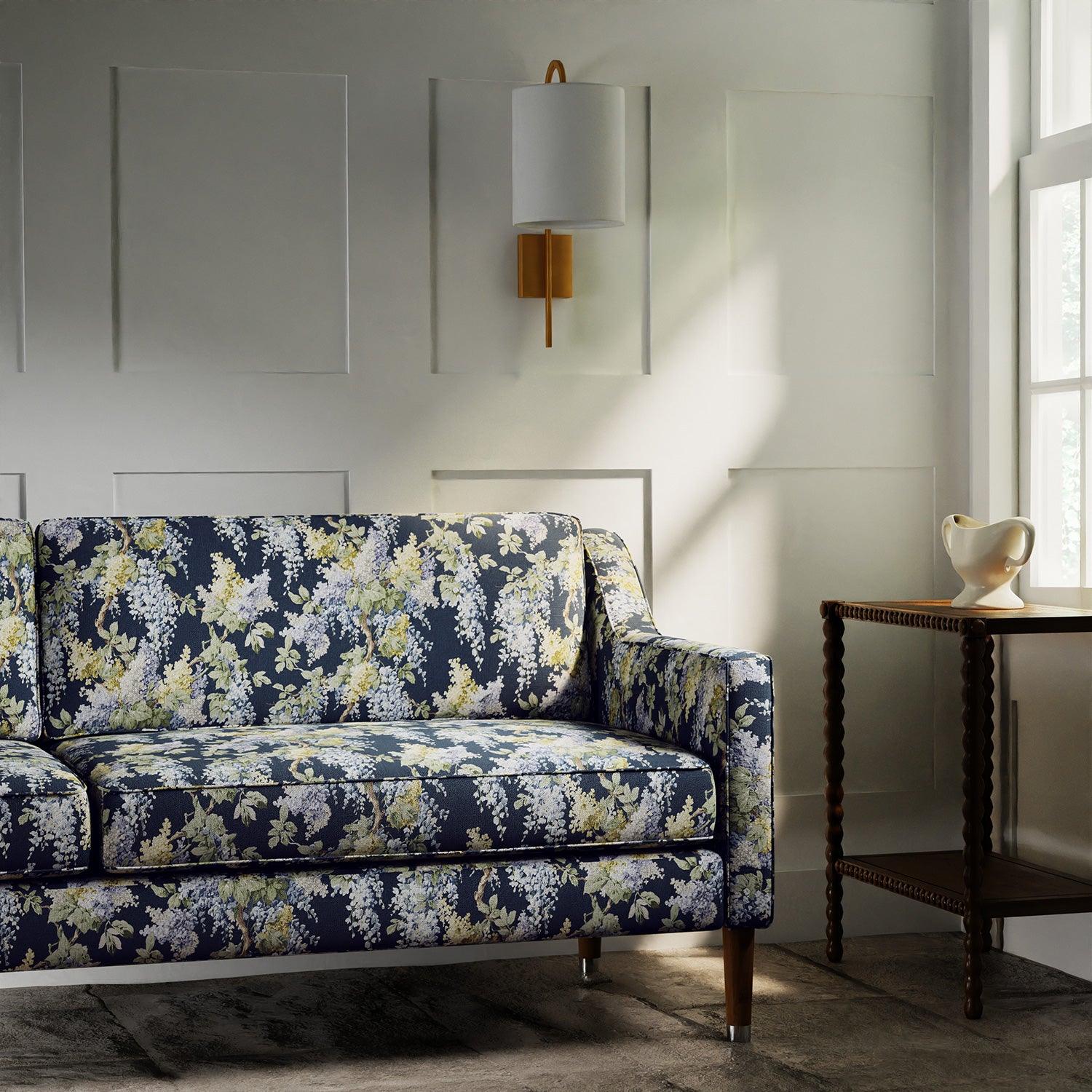 Sofa in a printed linen fabric with a wisteria floral pattern in blue and green colours.