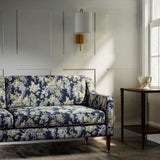 Sofa in a printed linen fabric with a wisteria floral pattern in blue and green colours.