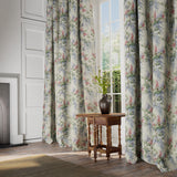 Curtains in a printed linen fabric with a wisteria floral pattern in light colours.