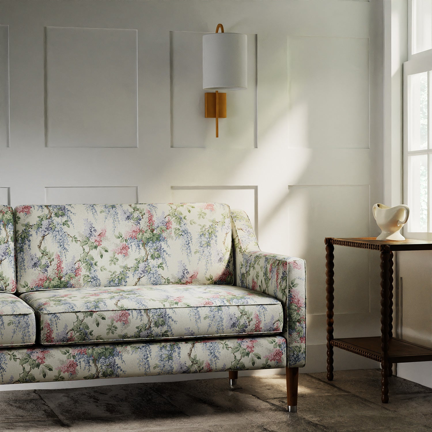Sofa in a printed linen fabric with a wisteria floral pattern in light colours.