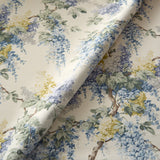 Printed linen fabric with wisteria floral pattern in blue, green and yellow colours for linen curtains, blinds and upholstery.