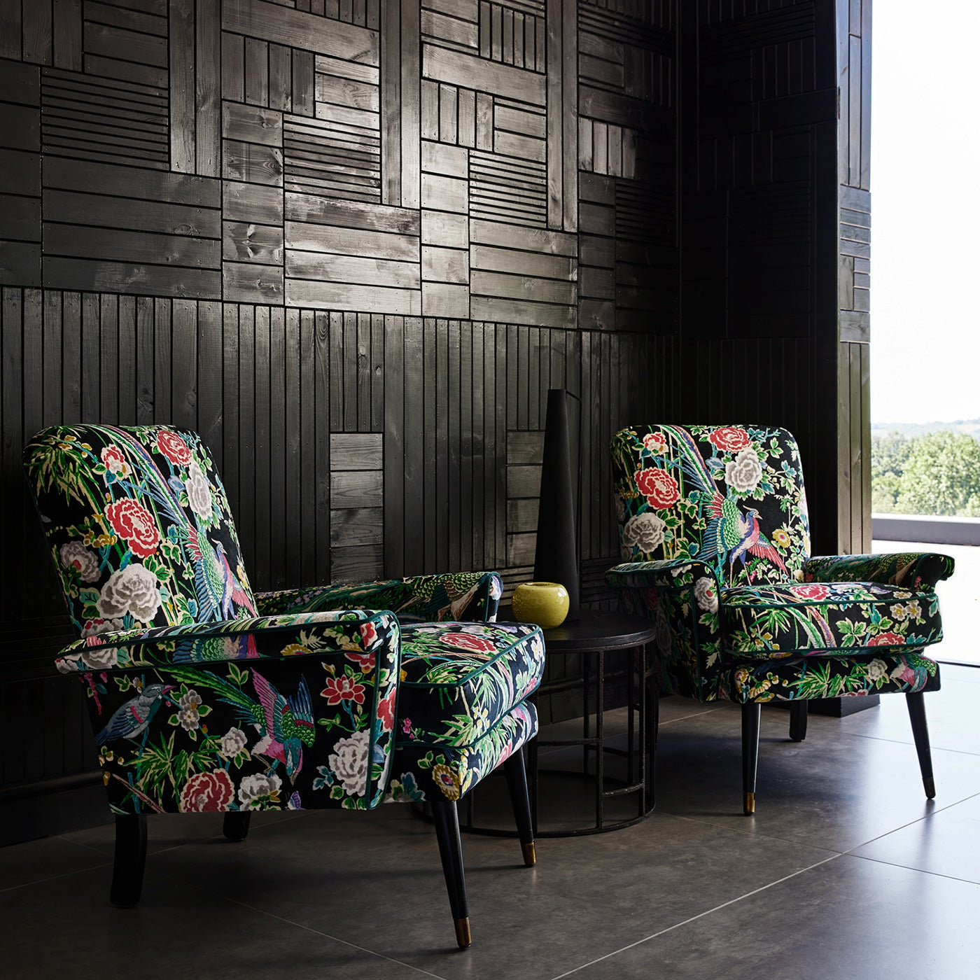 Velvet armchairs upholstered in a printed velvet fabric with bamboo and oriental flowers, in multicolours.