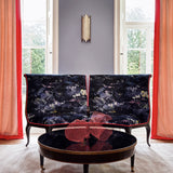 Armchairs in printed velvet fabric with painterly-style skyscape design in blue colours.