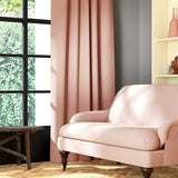 Living room featuring a sofa and curtains in a plain pastel pink eco-friendly fabric