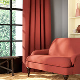 Living room featuring a sofa and curtains in a plain orange eco-friendly fabric