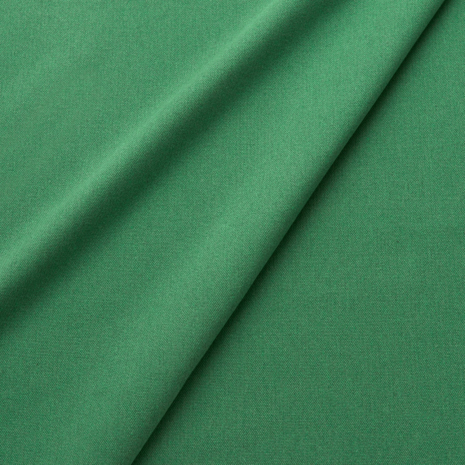 Fabric swatch of a eco-friendly plain emerald green fabric for curtains and upholstery
