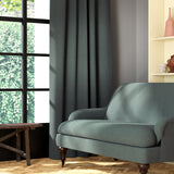Living room featuring a sofa and curtains in a plain grey eco-friendly fabric