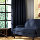 Living room featuring a sofa and curtains in a plain midnight blue eco-friendly fabric