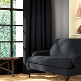 Living room featuring a sofa and curtains in a plain black eco-friendly fabric