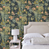 Bedroom with a tropical wallpaper in navy with exotic, floral blossoms intertwined with bamboo.