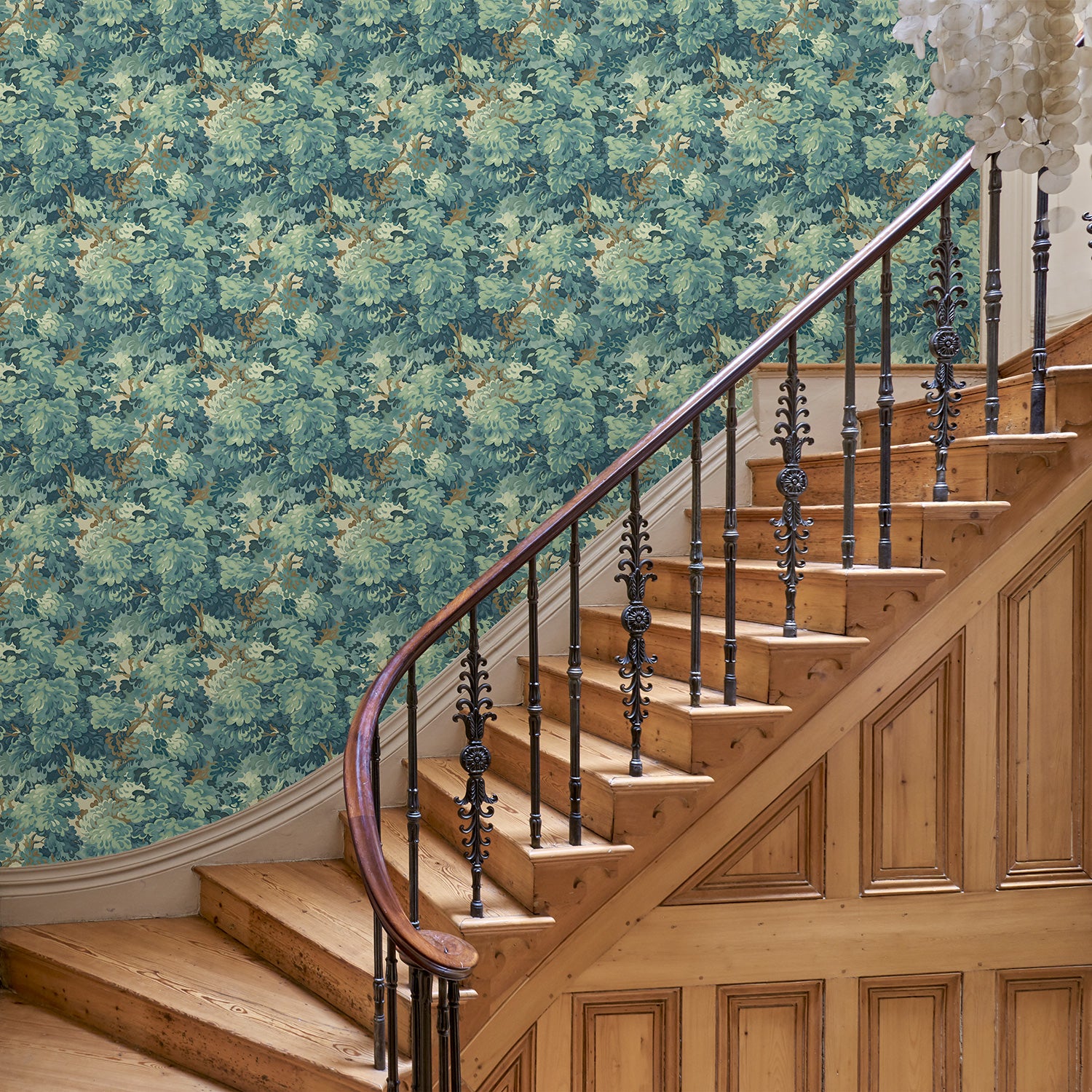 Inspired by an 18th-century garden tapestry, this blue wallpaper features the timeless beauty of English Oak canopies