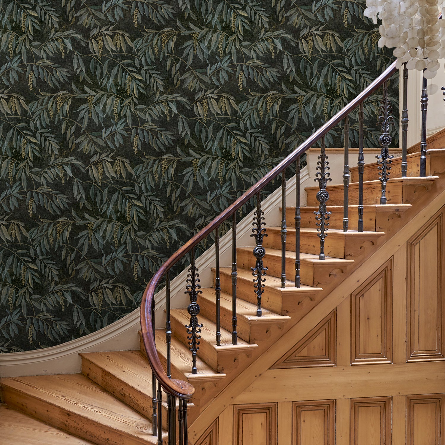 Showcasing stylised wisteria, this designer wallpaper features brown and green colours.