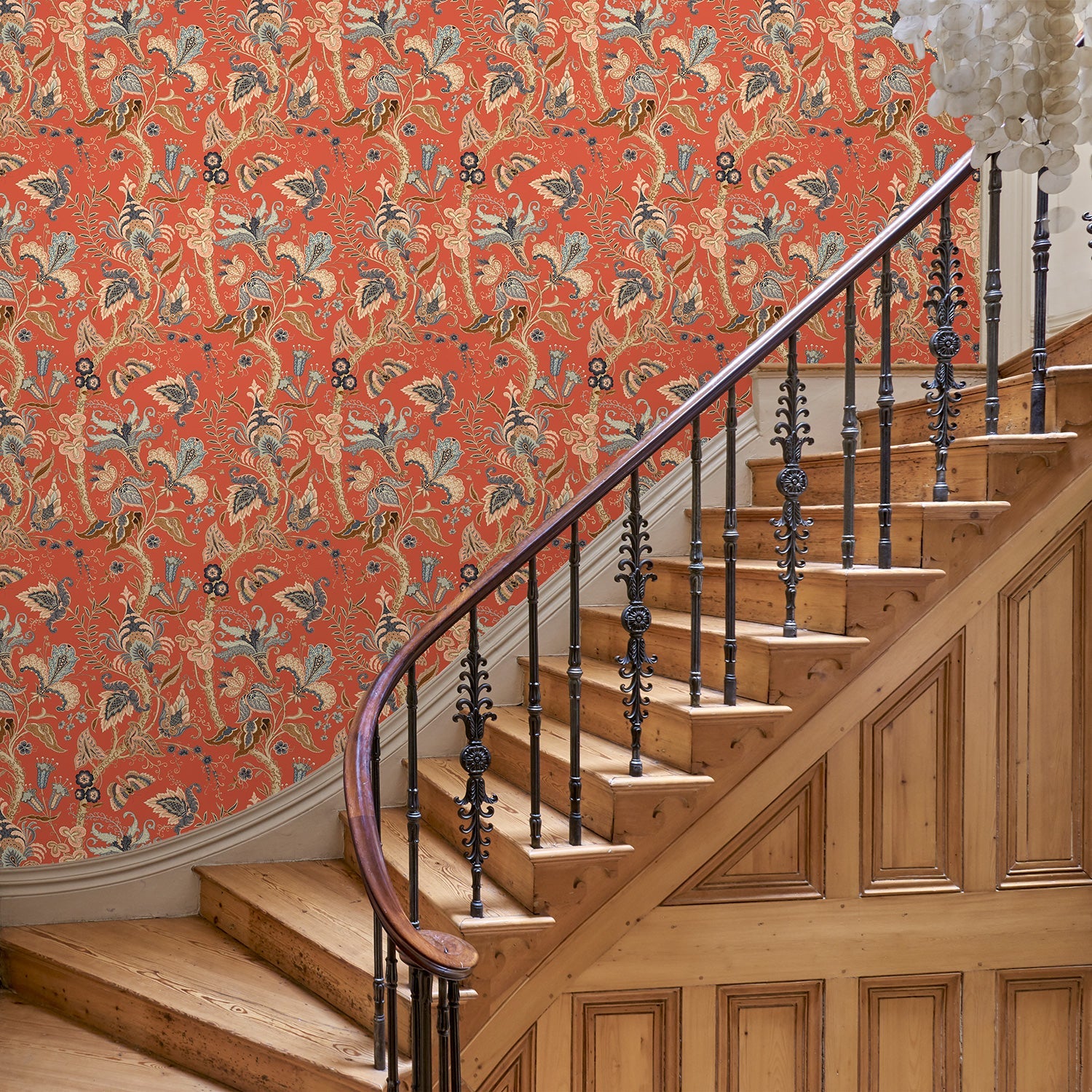 Hallway with a tropical wallpaper in chilli showcasing beautiful botanicals and butterflies.