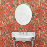 Bathroom with a tropical wallpaper in chilli showcasing beautiful botanicals and butterflies.