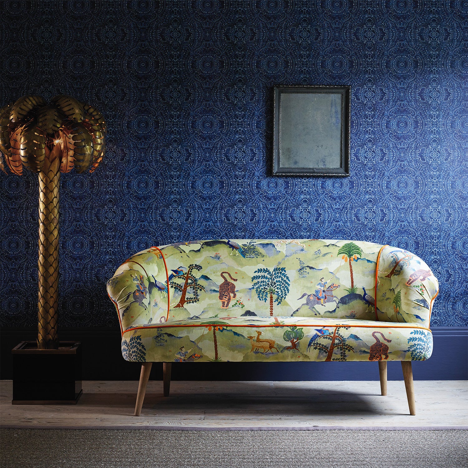 Sofa upholstered in a green cotton velvet fabric with painted animals and characters