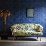 Sofa upholstered in a green cotton velvet fabric with painted animals and characters