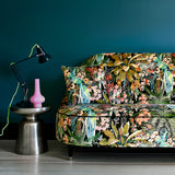 Sofa covered in a printed velvet fabric showcasing a tropical design