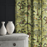 Curtains in a green cotton velvet with a painted mythical land with animals and characters