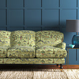 Sofa upholstered in a green cotton velvet fabric with painted animals and characters