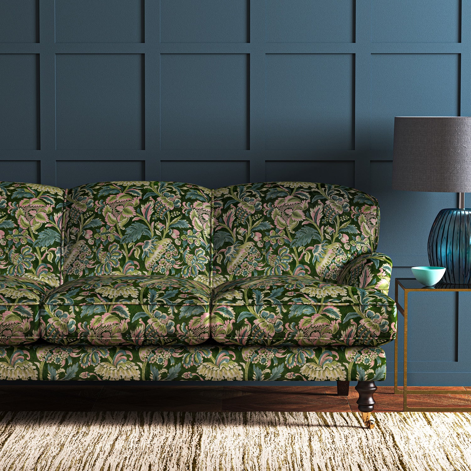 A printed velvet fabric showcasing an archival document, circa 1700s, this stylised floral is lavish, graceful, and timeless in green on a sofa
