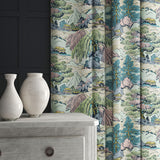 A printed velvet fabric showcasing a beautiful landscape of mountains, willows, and Oriental-style buildings in blue, pink and green, shown as curtains