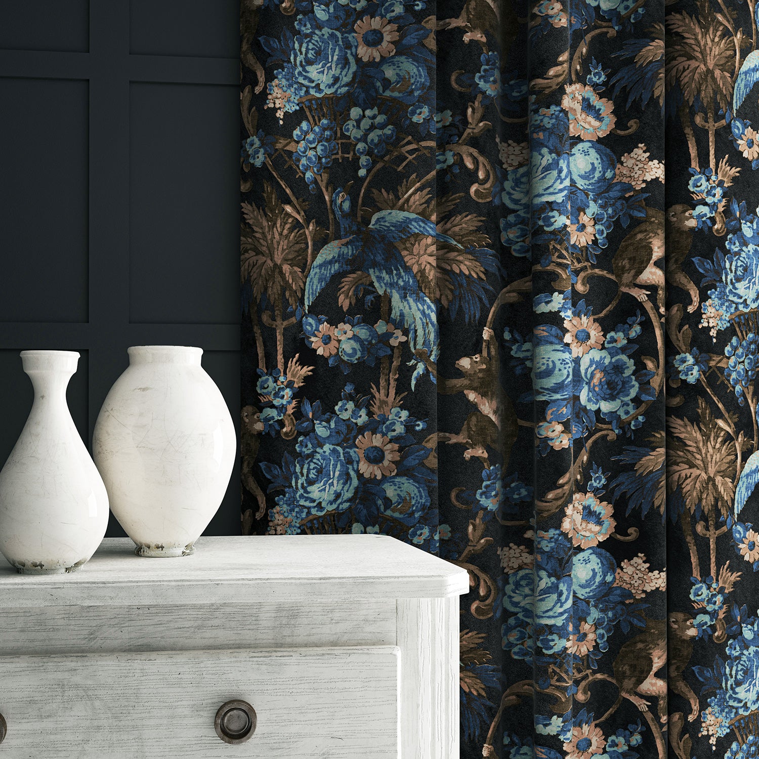 A printed velvet fabric showcasing a landscape of palms and monkeys in blue, brown and pink, as curtains