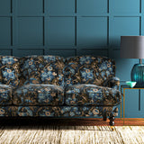 A printed velvet fabric showcasing a landscape of palms and monkeys in blue, brown and pink on a sofa