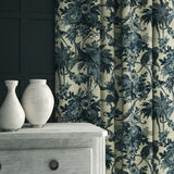A printed velvet fabric showcasing a landscape of palms and monkeys in blue and cream, as curtains