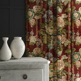 Curtains in a printed velvet fabric showcasing the abundant pattern of stylised flowers in red