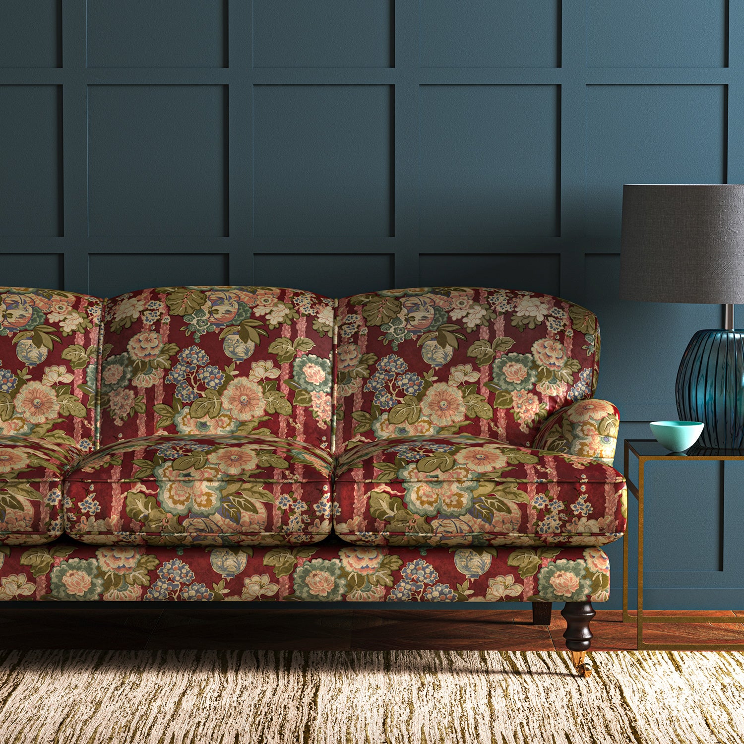 Sofa in a printed velvet fabric showcasing the abundant pattern of stylised flowers in red