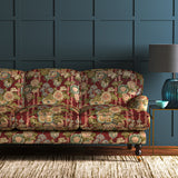 Sofa in a printed velvet fabric showcasing the abundant pattern of stylised flowers in red