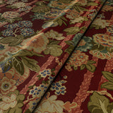 Sample of a printed velvet fabric showcasing the abundant pattern of stylised flowers in red