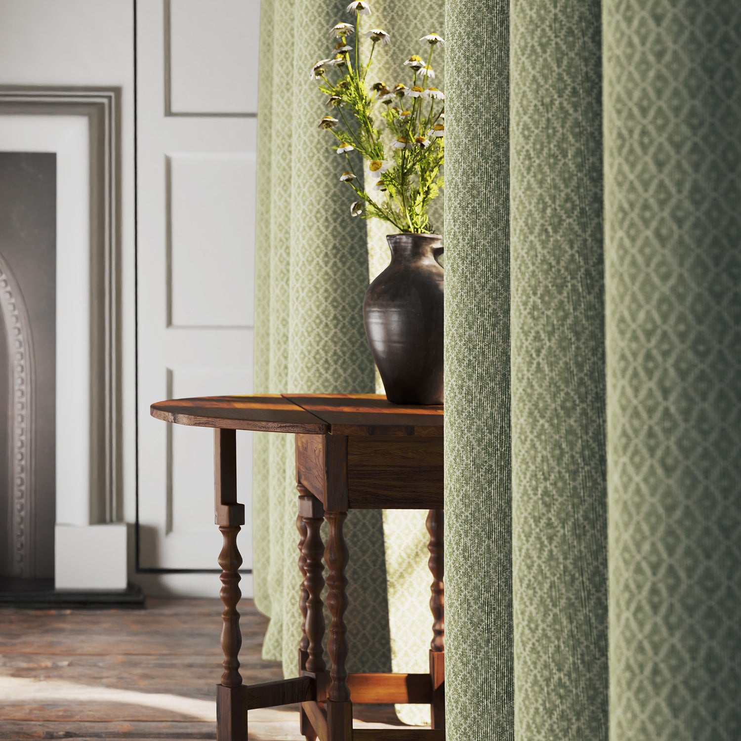 Curtains in a green and neutral printed linen fabric with a geometric pattern