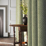 Curtains in a green and neutral printed linen fabric with a geometric pattern
