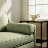 Sofa upholstered in a green and neutral printed linen fabric with a geometric pattern