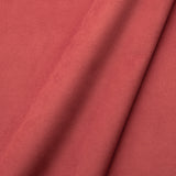 Fabric swatch of a plain stain resistant velvet upholstery fabric in a coral colour