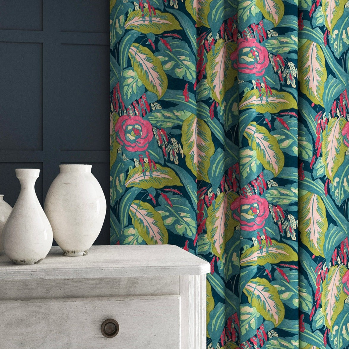 Curtains in a floral-style printed velvet fabric in pink, green and blue.