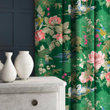 Velvet curtains in an emerald coloured floral pattern.